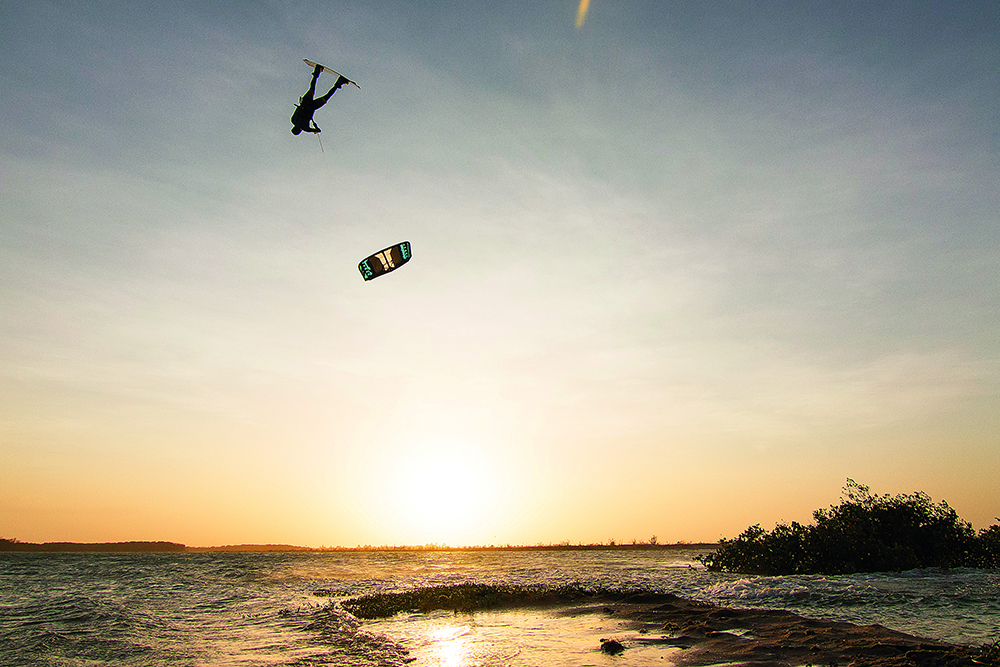 Slinghot’s boy wonder, Carlos Mario, with a mega-loop front roll high above the sunset in Barra Grande.
